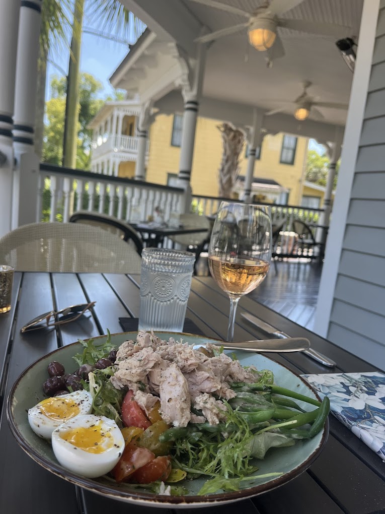 Outdoor Dining with wine and a cobb salad at La Nouvelle eatery in Saint Augustine florida